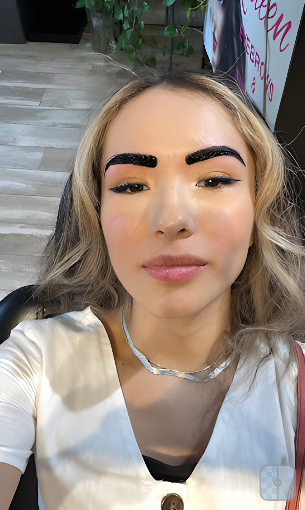 Client selfie showing fresh henna brows